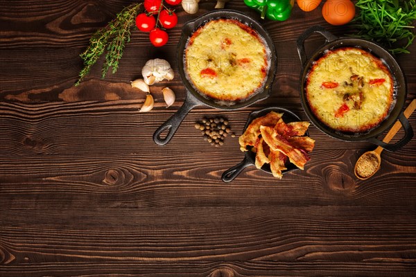 Table with cast-iron pan and spices
