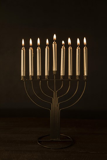 Menorah with golden burning candles
