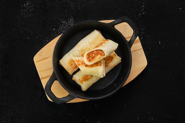 Thin pancakes stuffed with rabbit meat