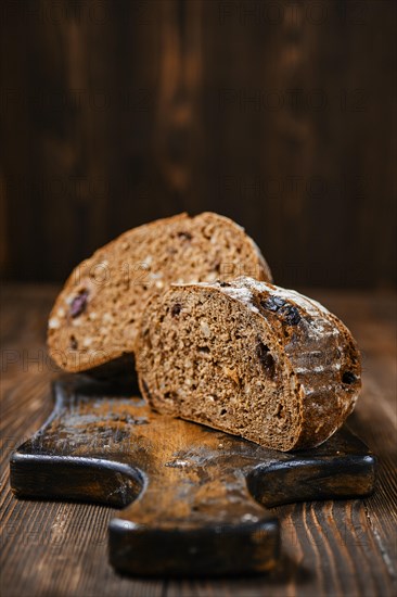 Closeup view of fresh rye brown bread on wooden cutting board
