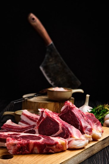 Selective focus photo of fresh raw rack of lamb on cutting board