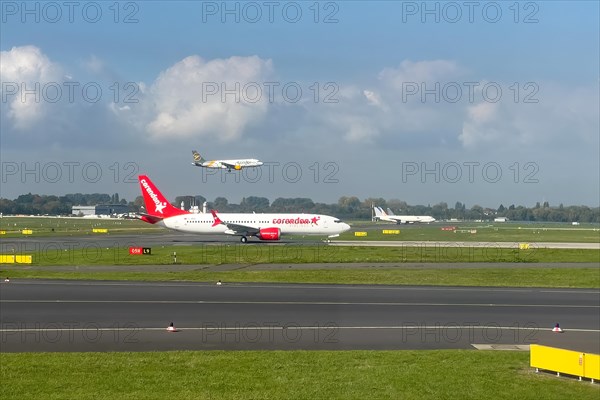 Two aircraft passenger jets jets jets jets in front Corendon Airlines in the back Condor on parallel runway runway during simultaneous takeoff takeoff and landing touchdown at Duesseldorf Internationa...