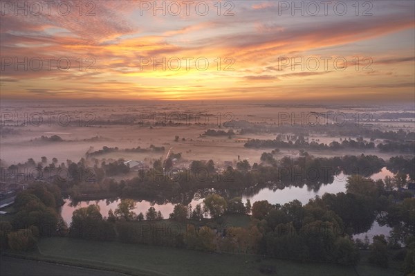 Aerial view of the landscape around Sandbraak Lake near Fuenfhausen in Hamburg's Kirchwerder district in autumnal morning atmosphere with light ground fog. In the background the nature reserve Kirchwe...