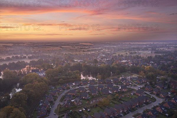 Aerial view of the landscape around Sandbraak Lake near Fuenfhausen in Hamburg's Kirchwerder district in autumnal morning atmosphere with light ground fog. In the foreground the residential area Fritz...