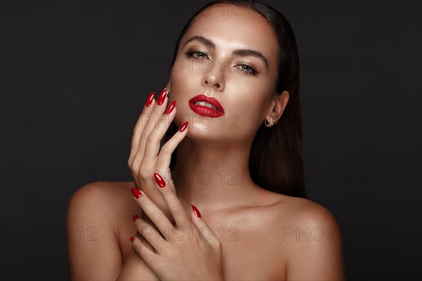 Beautiful girl with a classic make up and multi-colored nails. Manicure design. Beauty face. Photo taken in the studio