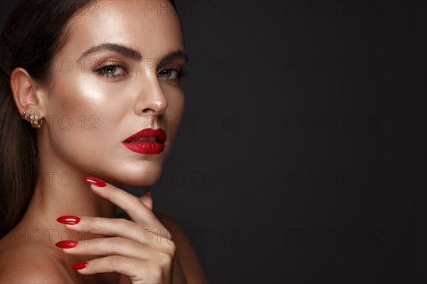 Beautiful girl with a classic make up and multi-colored nails. Manicure design. Beauty face. Photo taken in the studio