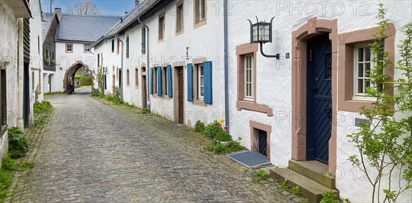 Historic alley with cobblestones in the background Gatehouse archway into old village Burgdorf 13th century Burgbering from today destroyed Kronenburg