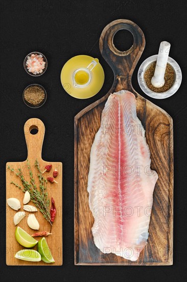 Fresh raw fillet of pangasius on black background