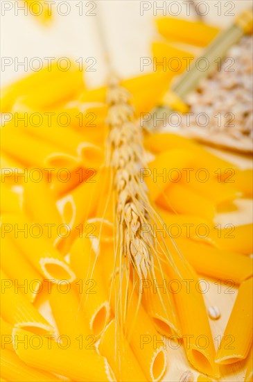 Short Italian pasta penne with durum wheat grains