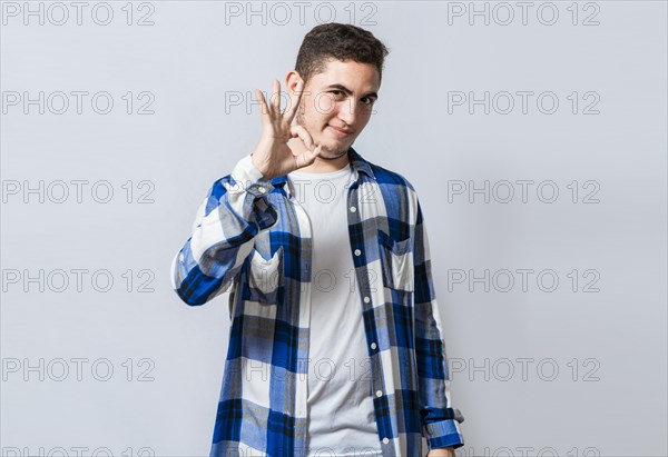 Handsome guy gesturing everything is ok