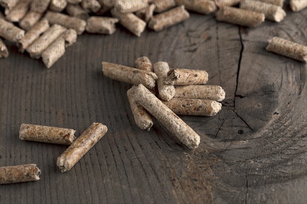 Wood pellets on wooden background