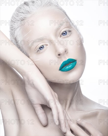 Beautiful girl in the image of albino with blue lips and white eyes. Art beauty face. Picture taken in the studio on a white background