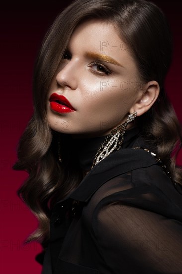 Beautiful girl with red lips and golden eyebrows