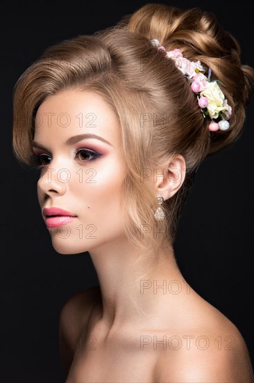 Portrait of a beautiful blond woman in the image of the bride. Picture taken in the studio on a black background. Beauty face and Hairstyle