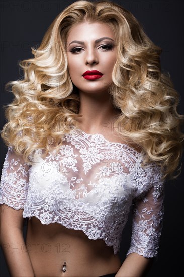 Beautiful blonde bride in wedding image with curls