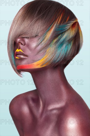 Beautiful girl with multi-colored hair and creative make up and hairstyle. Beauty face. Photo taken in the studio
