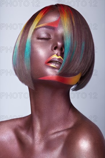 Beautiful girl with multi-colored hair and creative make up and hairstyle. Beauty face. Photo taken in the studio