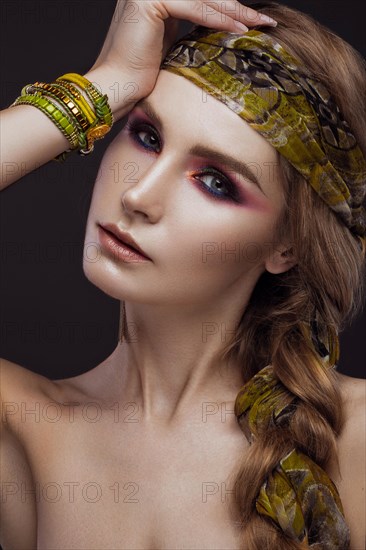 Beautiful fashion girl in a scarf and bracelets boho style. Beauty face