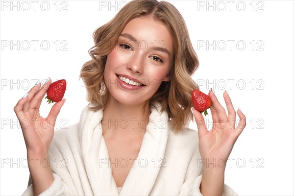 Beautiful tender young girl in a white coat with clean fresh skin posing in front of the camera. Beauty face. Skin care. Photo taken in studio on a white isolate background