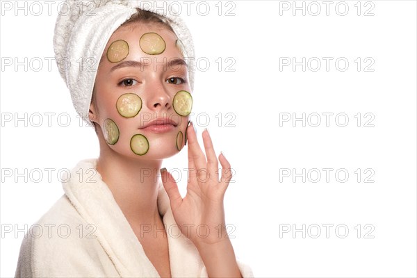 Beautiful tender young girl in a white towel with clean fresh skin posing in front of the camera. Beauty face. Skin care. Photo taken in studio on a white isolate background