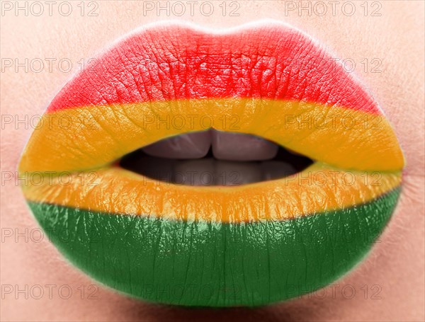 Female lips close up with a picture of the flag of Bolivia. Yellow