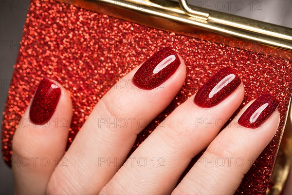 Bright festive red manicure on female hands. Nails design