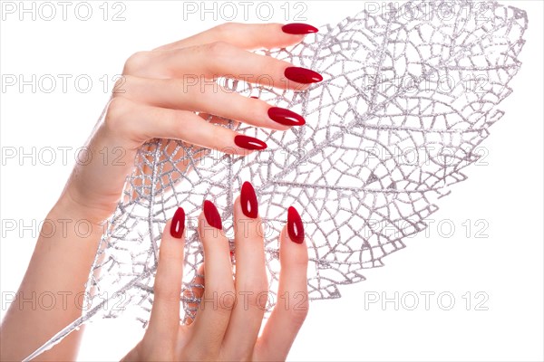 Bright festive red manicure on female hands. Nails design