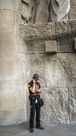 Uniformed police officer talking on his duty mobile phone