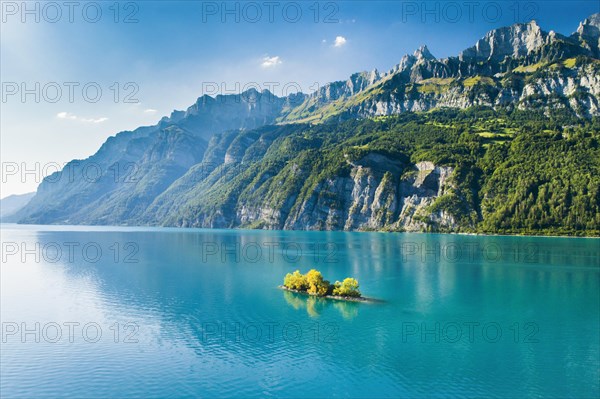 Aerial view of Lake Walen with a view of Chive Island in the turquoise water and Leistchamm and Churfirsten in the background
