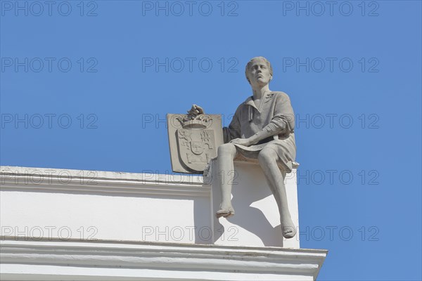 Sculpture figure with coat of arms on the roof of Asamblea Regional