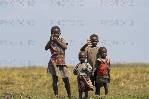 Children wave to tourists