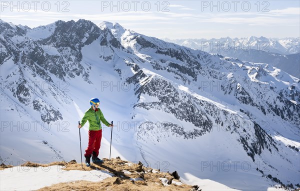 Hiker looking at Stubai Alps from Mitterzeigerkogel