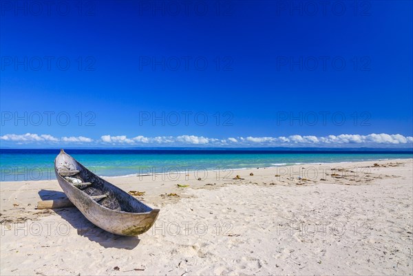 Canoe on a white sand beach on the Island Ile Sainte-Marie although Nosy Boraha