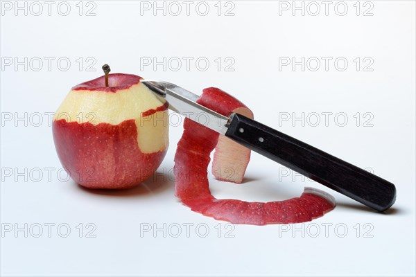 Peeled apple with peeling knife