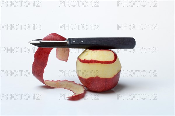 Peeled apple with peeling knife