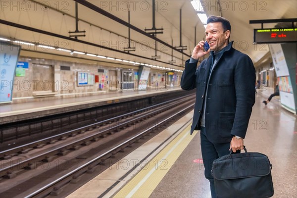 Middle-aged Caucasian businessman waiting on the subway for the train to go to work