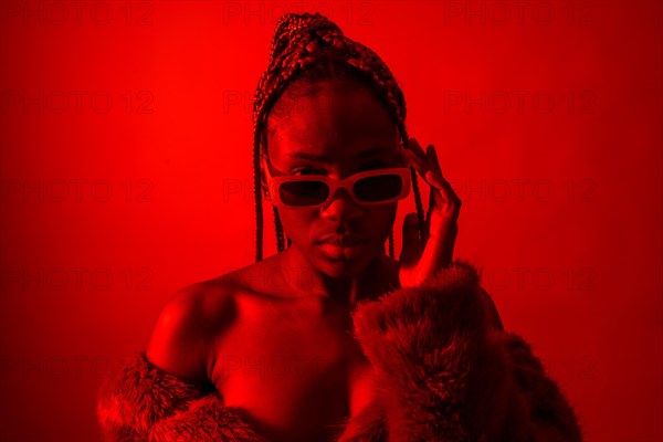Attractive black ethnic woman with braids with red led lights