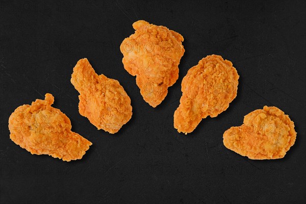 Top view of semifinished frozen chicken drumsticks ready for deep frying
