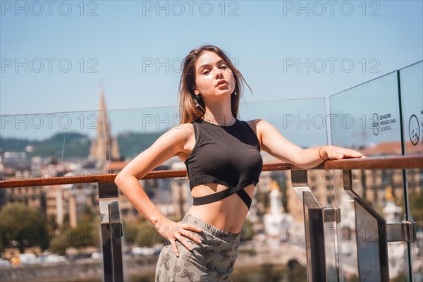 Portrait of a young model in a viewpoint of the city from the heights