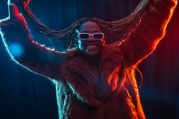 Black ethnic woman with braids with blue and red led lights