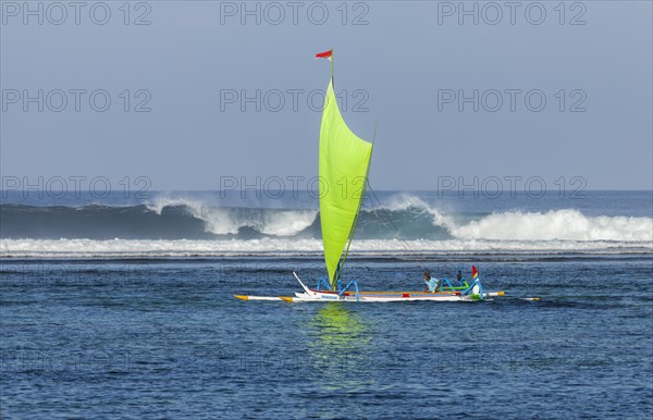 Brightly painted fishing outriggers on the beach at Sanur