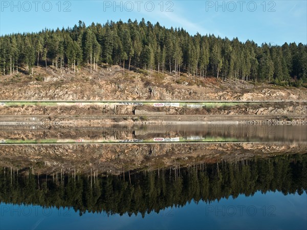 Reflection of the shore enclosure of the Schluchsee