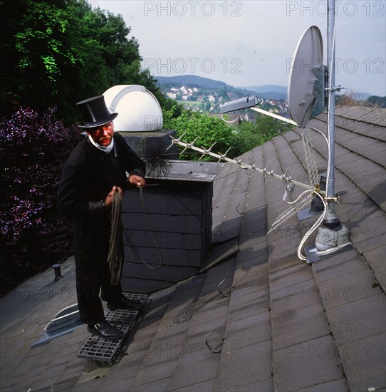 Chimney sweep in professional training and posing in a photo studio