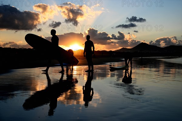 Surfers on the beach of Caleta de Famara