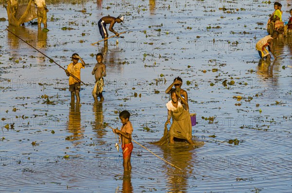 Locals fishing in a shallow lake