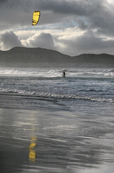 Kitesurfers at sunset on the beach of Caleta de Famara