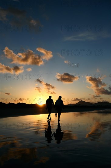 Sunset reflected on Caleta de Famara beach