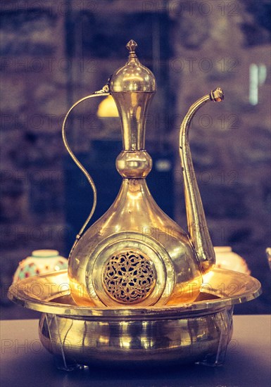 Very old style metal ewer water jar in view