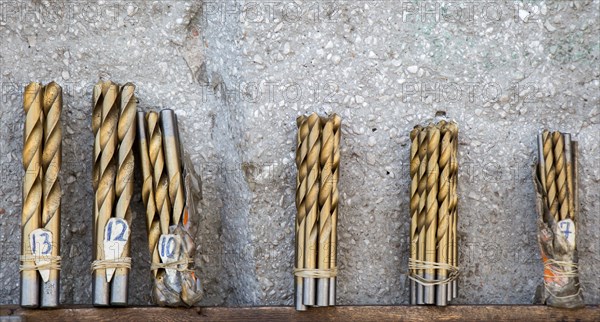 Drill bits grouped into different sizes in view