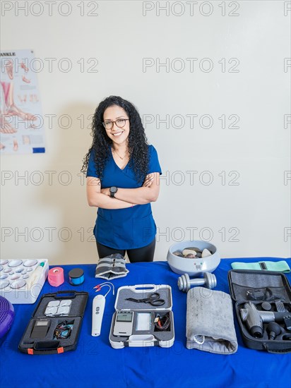 Physiotherapist with physiotherapy accessories. Smiling physiotherapist showing physiotherapy accessories